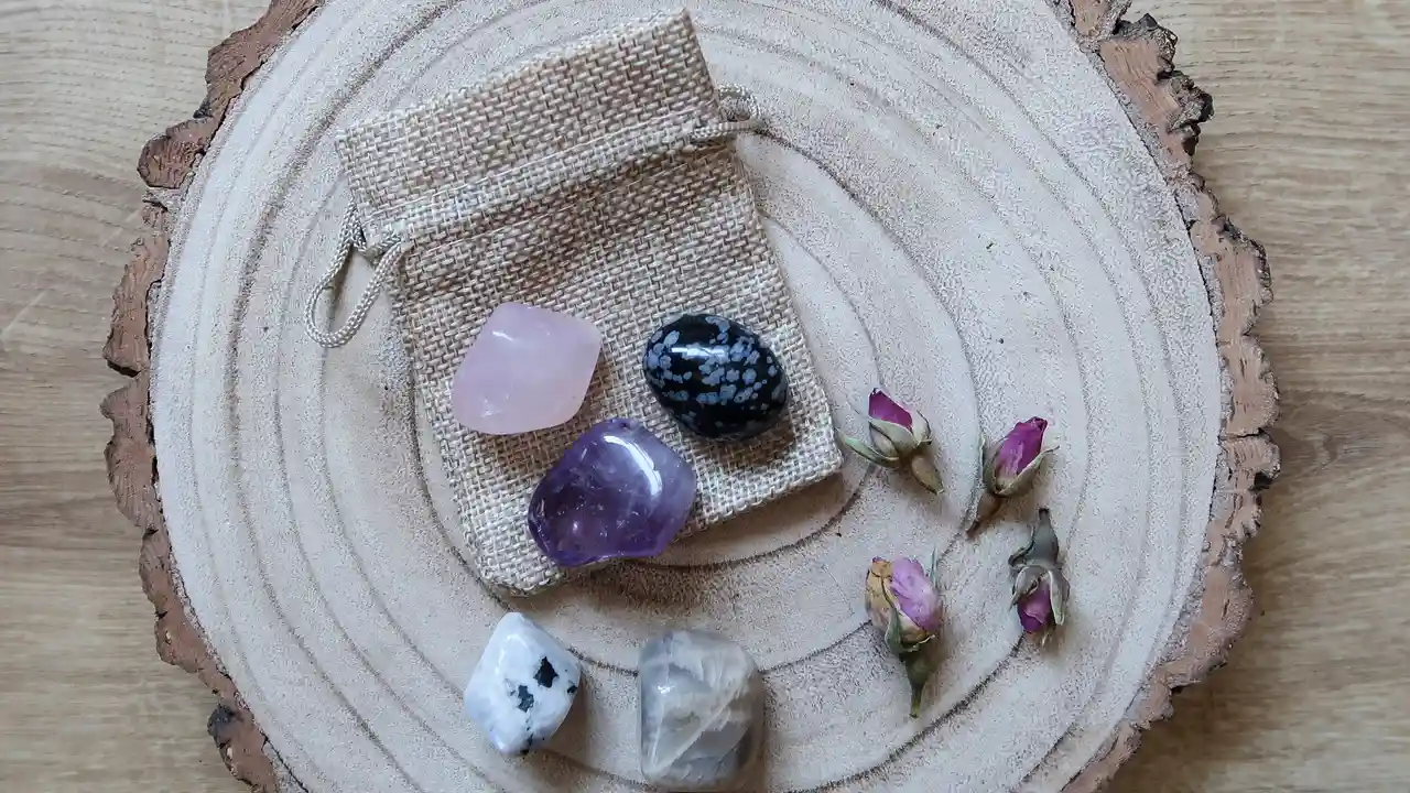 blue bowl of black bean beef tortilla soup on a board with cilantro and shredded cheese in background